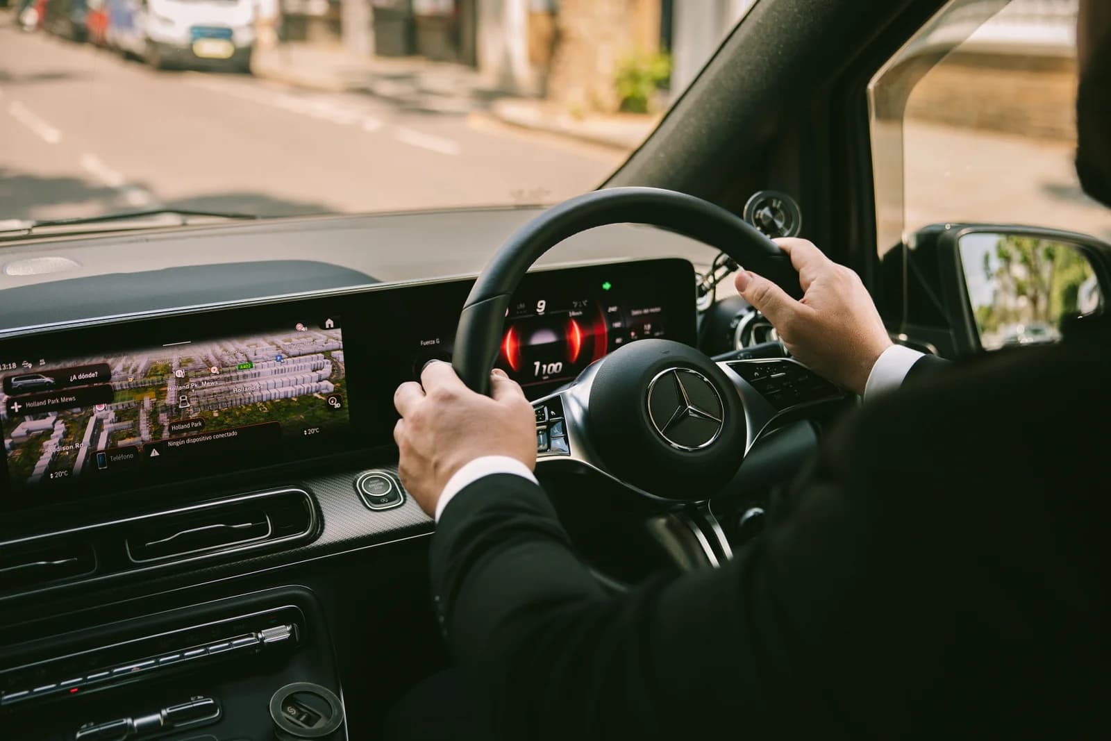 Professional chauffeur driving a luxury Mercedes